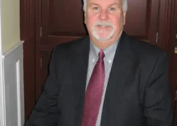 Tom Oakes, Editor of Philly Legal News, wearing a dark suit and red tie