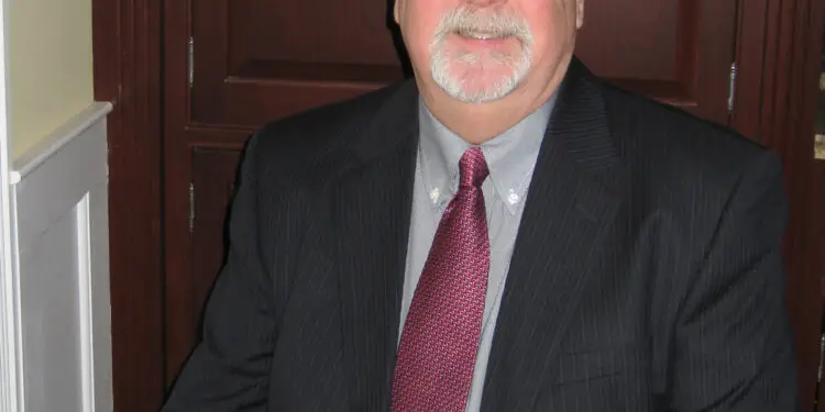 Tom Oakes, Editor of Philly Legal News, wearing a dark suit and red tie