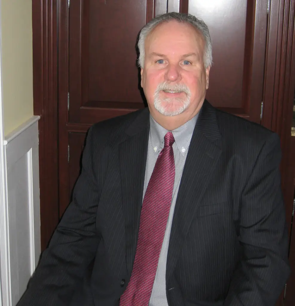 Tom Oakes, Editor of Philly Legal News, wearing a dark suit and red tie
