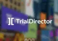 Logo of TrialDirector displayed on a digital screen over a blurred background of colourful lights.