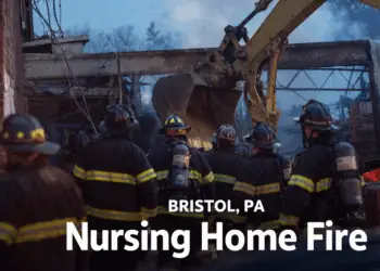 Firefighters and an excavator working at the scene of the Bristol, PA nursing home fire after the December 2025 explosion.