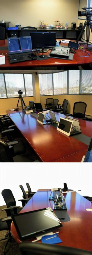 Conference room configured for an early realtime deposition with multiple computer monitors, attorney workstations, witness display screens, video equipment, and networked realtime transcription technology.